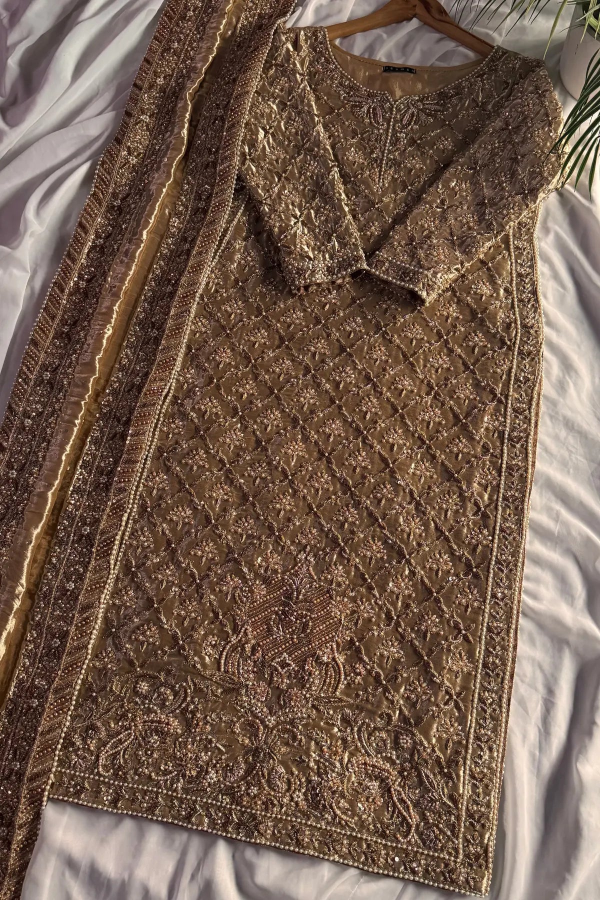 Brown textured scarf and vest set on a white fabric background